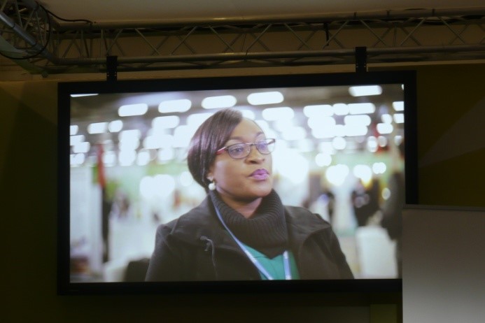 One of the screens showing the YCD video at COP21, which includes comments from Shamiso. 