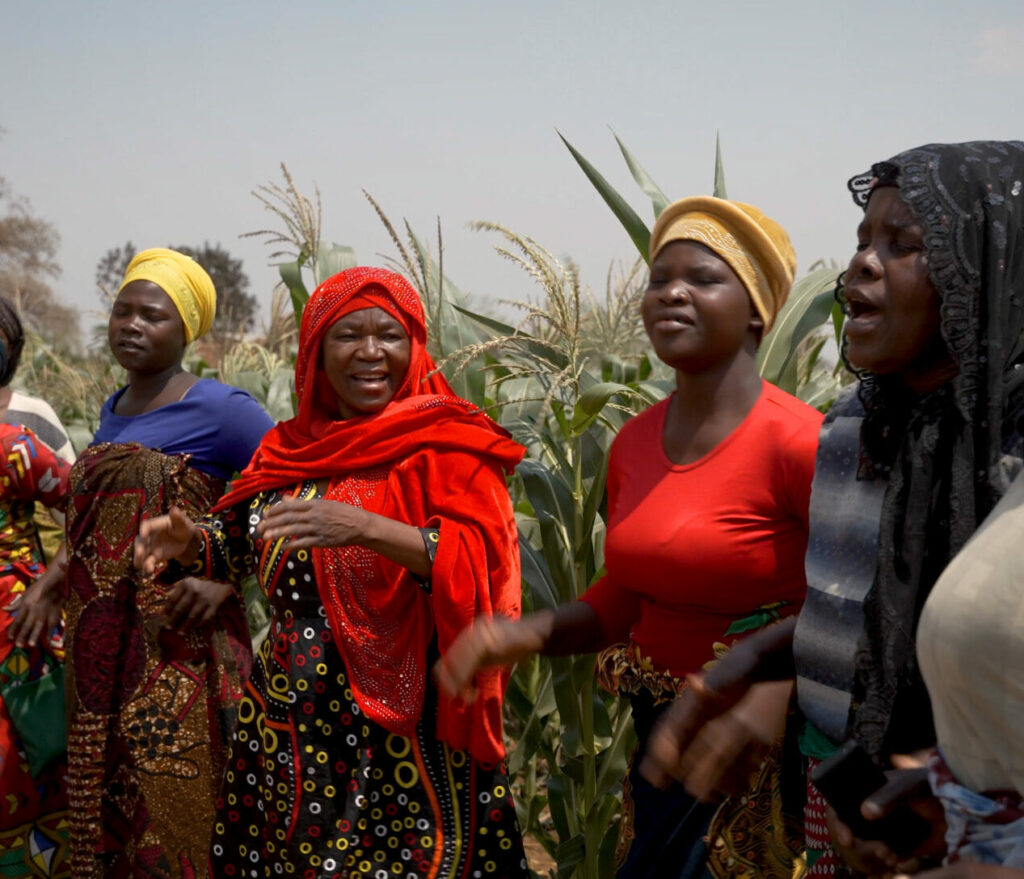 Women dancing in traditional African clothes.